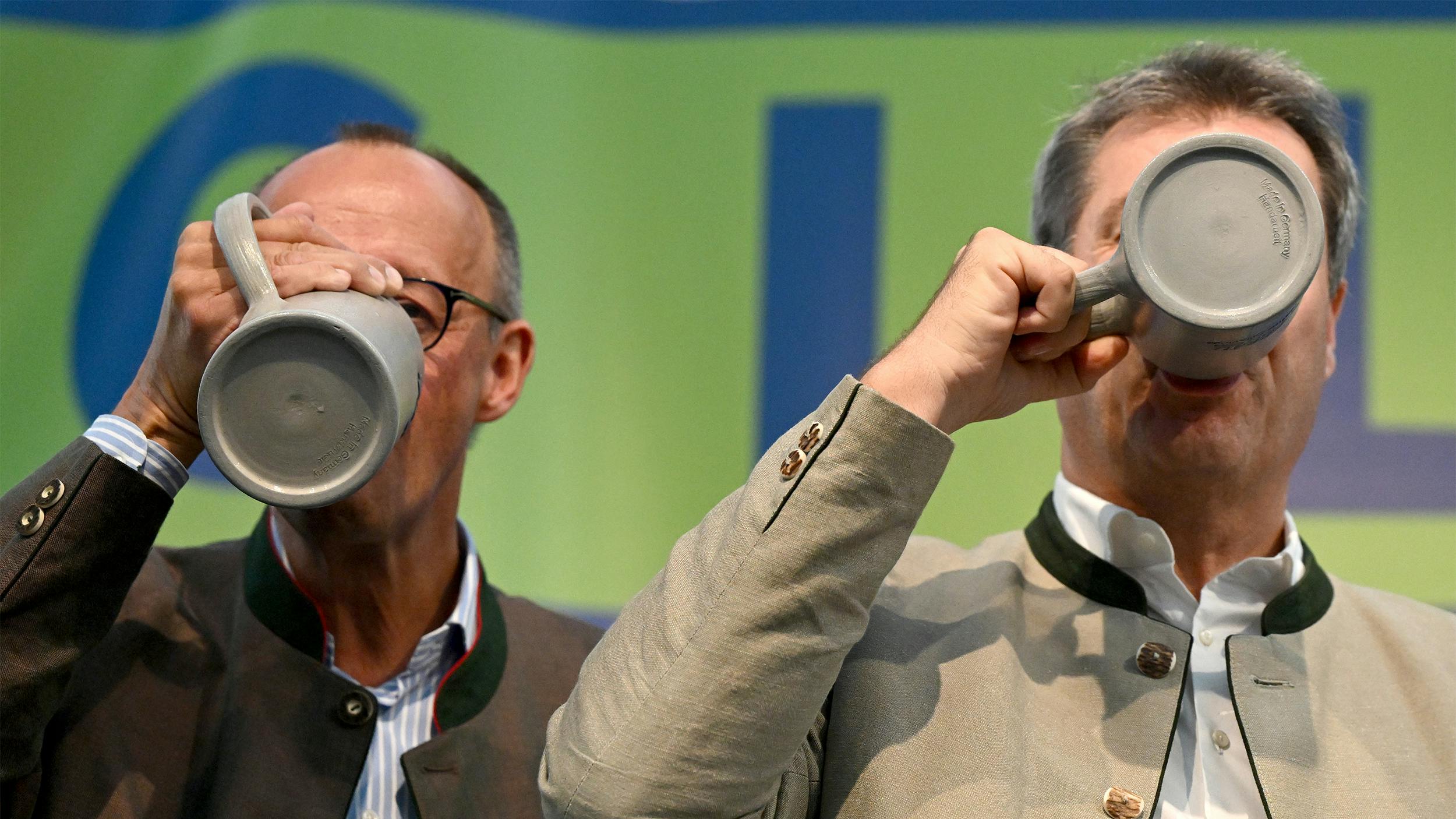 Friedrich Merz und Markus Söder trinken beim Frühschoppen auf dem Gillamoos eine Maß Bier. September 2023. 